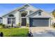 Charming single-story home with a well-manicured lawn and a two-car garage at 3686 Ricky Ln, St Cloud, FL 34772