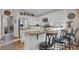 Bright kitchen featuring white cabinetry, stainless steel appliances, and breakfast bar with stool seating at 3686 Ricky Ln, St Cloud, FL 34772