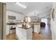 Open kitchen with white cabinets, stainless steel appliances, and center island at 3686 Ricky Ln, St Cloud, FL 34772