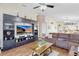 Open concept living room with built-in entertainment center and leather sofa at 3686 Ricky Ln, St Cloud, FL 34772