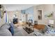 Spacious living room with high ceilings, fireplace, and plush grey sofa at 3686 Ricky Ln, St Cloud, FL 34772
