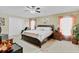 Main bedroom with neutral tones, large windows, ceiling fan, and comfortable furnishings at 3686 Ricky Ln, St Cloud, FL 34772