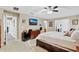 Large main bedroom features TV, ceiling fan, decor, and ensuite bathroom at 3686 Ricky Ln, St Cloud, FL 34772