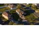Aerial view of a property with manicured lawn, mature trees, brick driveway in a well-kept neighborhood at 4301 Presidio Way, Kissimmee, FL 34746