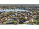 Aerial view of a residential neighborhood with a lake and mature trees at 4301 Presidio Way, Kissimmee, FL 34746