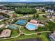Aerial view of community amenities, including a pool, tennis courts, and lush landscaping at 4301 Presidio Way, Kissimmee, FL 34746