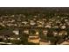 An aerial view captures a community with numerous houses, mature trees, and winding roads, highlighting the area's serene setting at 4301 Presidio Way, Kissimmee, FL 34746