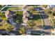 Aerial shot of a well-maintained home featuring a manicured lawn, mature trees, and an extended driveway on a quiet street at 4301 Presidio Way, Kissimmee, FL 34746