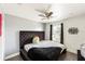 Cozy bedroom features a tufted headboard, a ceiling fan, and ample natural light at 4301 Presidio Way, Kissimmee, FL 34746