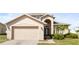Inviting home featuring an attached two-car garage and nicely landscaped front yard at 4301 Presidio Way, Kissimmee, FL 34746