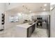 Modern kitchen featuring an island with quartz countertop, stainless steel appliances, and gray cabinetry at 4301 Presidio Way, Kissimmee, FL 34746