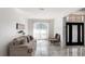 Bright living room featuring marble floors, a large window, and comfortable seating at 4301 Presidio Way, Kissimmee, FL 34746