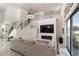 Modern living room featuring marble floors, a fireplace, and a staircase to the second floor at 4301 Presidio Way, Kissimmee, FL 34746