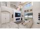 Modern living area features marble floors, large windows, fireplace, and a cozy sofa at 4301 Presidio Way, Kissimmee, FL 34746
