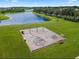 Aerial view of a lakeside community playground with swings, climbing dome and benches at 4301 Presidio Way, Kissimmee, FL 34746