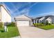 Charming single-Gathering home features a well-manicured lawn, inviting facade, and an attached two-car garage at 4479 Blue Rock Dr, Sanford, FL 32771