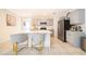 Bright, open kitchen featuring a large center island with white countertops and gray cabinets with stainless appliances at 4479 Blue Rock Dr, Sanford, FL 32771