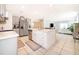 Bright, open kitchen featuring a large center island with white countertops and gray cabinets with stainless appliances at 4479 Blue Rock Dr, Sanford, FL 32771