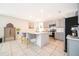 Bright, open kitchen featuring a large center island with white countertops and gray cabinets with stainless appliances at 4479 Blue Rock Dr, Sanford, FL 32771