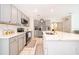 Bright, open kitchen featuring a large center island with white countertops and gray cabinets with stainless appliances at 4479 Blue Rock Dr, Sanford, FL 32771