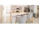 Bright, open kitchen featuring a large center island with white countertops and gray cabinets with stainless appliances at 4479 Blue Rock Dr, Sanford, FL 32771