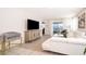 Bright living room featuring wood floors, a flat-screen TV, and water views at 4479 Blue Rock Dr, Sanford, FL 32771