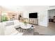 Bright living room featuring tile floors, white sofas, and an open floor plan with kitchen at 4479 Blue Rock Dr, Sanford, FL 32771