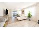 Bright living room featuring tile floors, a white leather sofa, and water views at 4479 Blue Rock Dr, Sanford, FL 32771