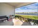 Screened in patio overlooking a lake with black bench and grill at 4479 Blue Rock Dr, Sanford, FL 32771