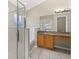 Bright bathroom featuring a glass shower, soaking tub, and granite countertops at 4614 Falcon Ave, Kissimmee, FL 34746