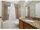 Bathroom featuring a tub with shower, toilet, and granite vanity at 4614 Falcon Ave, Kissimmee, FL 34746