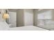 Bright bedroom featuring a full-size bed, window with blinds, closet, and neutral decor at 4614 Falcon Ave, Kissimmee, FL 34746