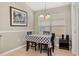 Bright dining area with table and chairs under chandelier lighting near a large window at 4614 Falcon Ave, Kissimmee, FL 34746