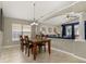 Bright dining area with furniture and view of a living area with blue accents at 4614 Falcon Ave, Kissimmee, FL 34746