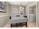Bright dining area with table and chairs under chandelier lighting near a laundry room at 4614 Falcon Ave, Kissimmee, FL 34746