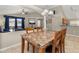 Open-concept dining area featuring a stone table with seating and views of the living room at 4614 Falcon Ave, Kissimmee, FL 34746