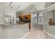 Open kitchen with breakfast bar leading to entryway and stainless steel appliances at 4614 Falcon Ave, Kissimmee, FL 34746
