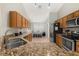 Well-lit kitchen featuring granite countertops, stainless steel appliances, and wooden cabinets at 4614 Falcon Ave, Kissimmee, FL 34746