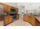 Bright kitchen with granite countertops, stainless steel appliances, and view of living space at 4614 Falcon Ave, Kissimmee, FL 34746