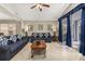 Inviting living room with blue sofas and a patio view, filled with natural light at 4614 Falcon Ave, Kissimmee, FL 34746