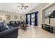 Comfortable living room with plush seating, a ceiling fan, and access to the screened porch at 4614 Falcon Ave, Kissimmee, FL 34746