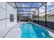 Enclosed pool area with a beautiful, kidney-shaped pool and ample seating at 4614 Falcon Ave, Kissimmee, FL 34746