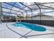 Stunning view of a private screened-in pool with lounge chairs for relaxing by the water at 4614 Falcon Ave, Kissimmee, FL 34746