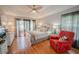 Bright main bedroom featuring a ceiling fan, tray ceiling, and sliding glass doors to the home's exterior at 4809 Jeanette Ct, St Cloud, FL 34771