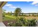 Backyard area featuring lush landscaping and a serene view of the adjacent lake at 486 Lake Shore Pkwy, Davenport, FL 33896