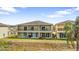 Townhome featuring a serene outdoor space with patios or balconies, overlooking lush landscaping at 486 Lake Shore Pkwy, Davenport, FL 33896