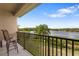 Outdoor balcony with seating overlooking peaceful lake at 486 Lake Shore Pkwy, Davenport, FL 33896