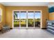 Bright living space offers serene views of the lake through sliding glass doors at 486 Lake Shore Pkwy, Davenport, FL 33896