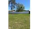 The large backyard is enclosed with a tall white fence at 49 Inconnu Dr, Poinciana, FL 34759