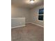 Bedroom with a neutral gray wall, carpet, and natural light from a window at 49 Inconnu Dr, Poinciana, FL 34759
